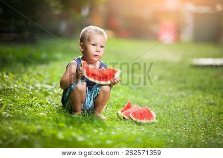Cute Toddler Eating A Slice Of Watermelon