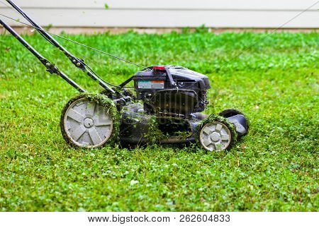 Push Lawnmower In Action With Grass Flying Around/ Lawncare Concept
