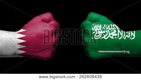 Flags Of Qatar And United Arab Emirates Painted On Two Clenched Fists Facing Each Other On Black Bac