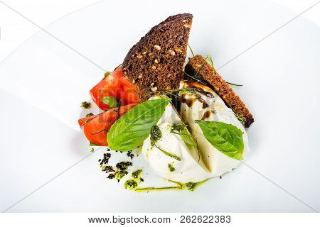Salad Of Red Ripe Tomatoes With Green Parmesan Cheese With Black Bread And Bran On White Plate Isola