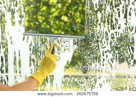 Janitor Cleaning Window With Squeegee Indoors, Closeup