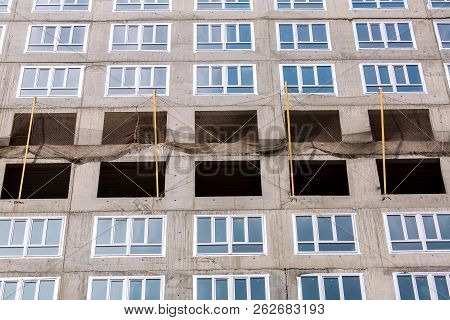 The Multystoried Building Under Construction With The Established Double-glazed Windows.