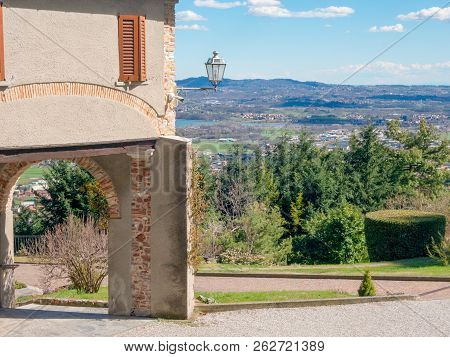 Corner Of The House With A Portico And A Street Lamp In The Mountains. Panormanic Top View Of The La