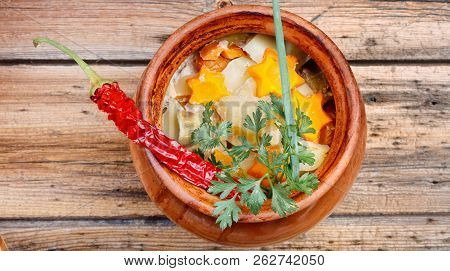 Traditional Rustic Home  Gulyas, With Raw Vegetables And Spices In Clay Pots On  Old Vintage Wooden 