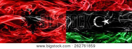 Albania Vs Libya, Libyan Smoke Flags Placed Side By Side. Thick Colored Silky Smoke Flags Of Albania