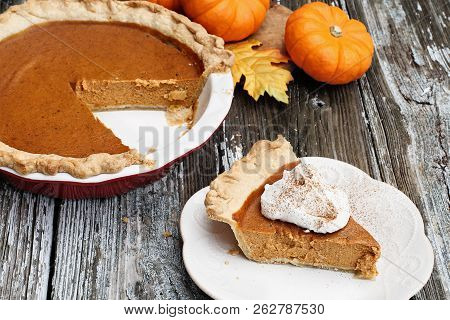 Slice Of Homemade Pumpkin Pie Over A Rustic Wooden Background. Extreme Shallow Depth Of Field With S