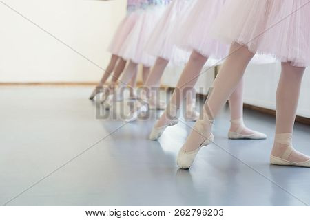Ballerinas In Pointe Shoes. Girls Stretching Legs Before Dance Lessons