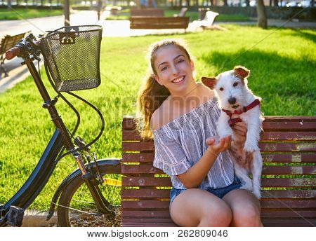 Girl with dog sitting in a park bench with turf grass background outdoor