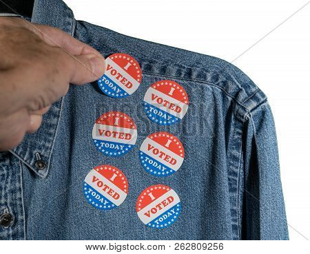 Hand Placing Multiple I Voted Today Stickers On The Blue Denim Working Shirt Collar For Midterm Elec