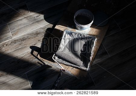 Coloring The Walls Of The Room. Tray With Paint Roller And Paint In The Light Of The Sun Falling Thr