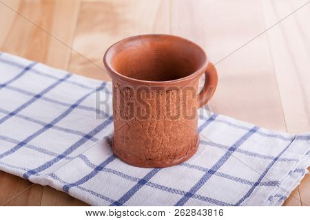 Coffee Served In White Mug With Tissue On Wooden Table