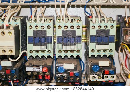 Several Old Relays With Connected Colored Wires. Industrial Background.