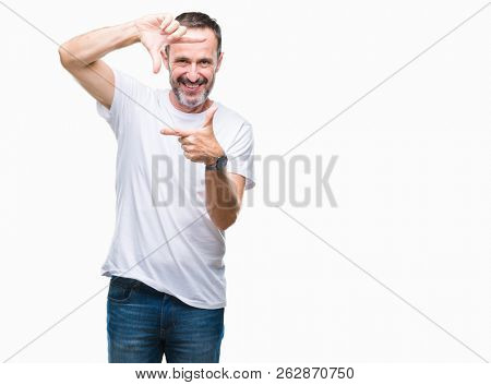 Middle age hoary senior man wearing white t-shirt over isolated background smiling making frame with hands and fingers with happy face. Creativity and photography concept.