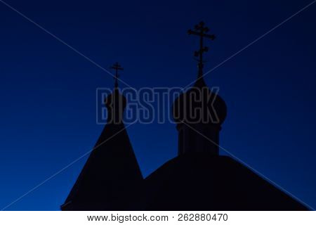 Silhouette Of Domes With Crosses Of Orthodox Church Against The Blue Sky In The Evening