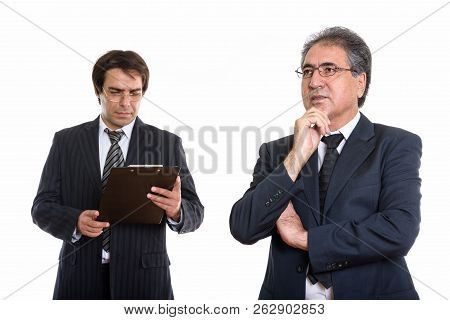 Senior Persian Businessman Thinking And Young Persian Businessma
