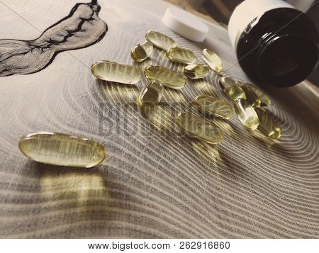 Fish Oil, Omega 3 Capsules On Wooden Table