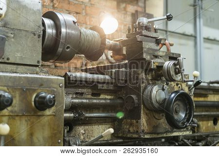Old Machinery In A Factory From The Mid-20th C. Working Machine-tool. Old Lathe.