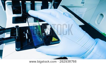 Frankfurt, Germany - July 27, 2017: Scientist With Dna Sequencing Chip. Medical Laboratory.
