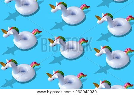 Inflatable Unicorn Pool Toy Pattern Onl Blue Background. Minimal Summer Concept.