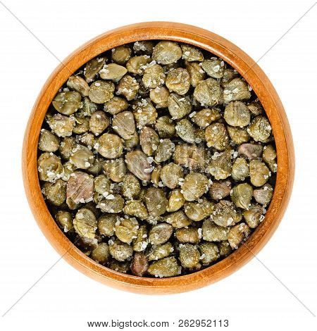 Salted Capers In Wooden Bowl. Green, Dried, Pickled In Sea Salt, Used As Seasoning Or Garnish. Flowe