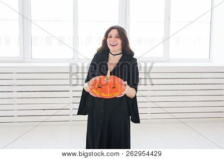 Halloween And Holidays Concept - Witch Woman With Jack Olantern Pumpkin