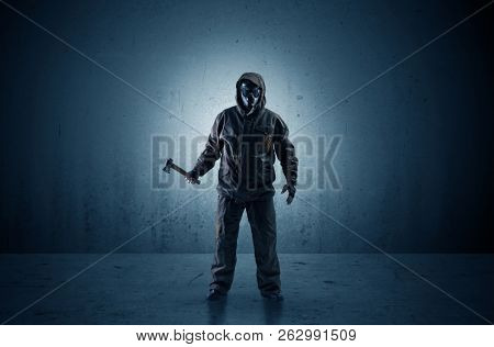 Bad agent in a dark room with arms on his hand and gas mask