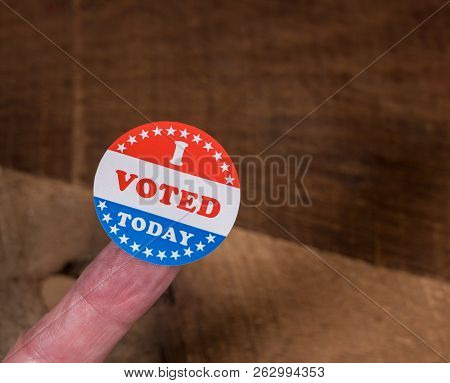 I Voted Today Sticker On Senior Caucasian Mans Finger On Rustic Rural Wooden Table