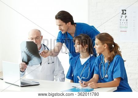 Medical Team Checking On X-ray Results At Clinical Office