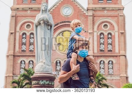 Father And Son In Medical Mask In The Background Notre Dame De Saigon Cathedral, Build In 1883 In Ho