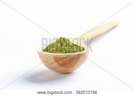 Wooden Spoon Full Of Green Japanese Matcha Tea Powder On White Background. Matcha Tea Is Natural Org