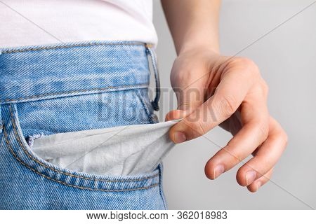 Woman Showing Empty Pockets With No Money. Bancruptcy Concept.
