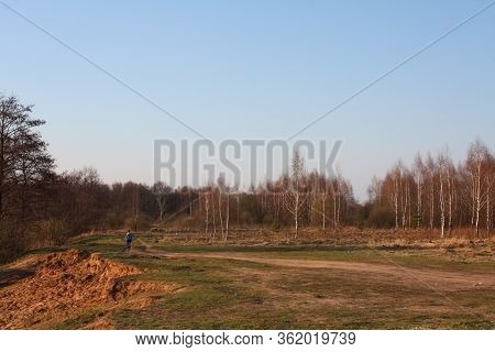 Beautiful Autumn Landscape With Autumn Nature. Sandy Cliff, Yellow Trees, Road With A Walking Girl,