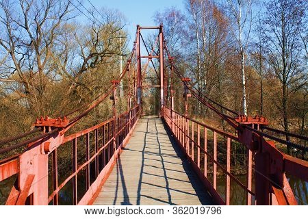A Large Red Iron Boat Through The River Among The Forest And Trees In The Fall. Yellow Nature On A S