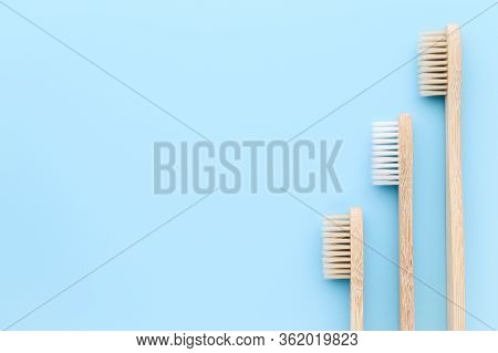 Zero Waste And Without Plastic Concept. Three Eco Friendly Bamboo Toothbrushes On A Light Blue Surfa