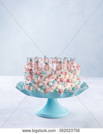 Colorful Buttercream Birthday Cake Decorated With Pink Buttercream Swirls Over A Blue Background. Sp