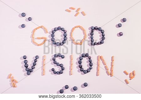 Vitamins And Supplements For Healthy Eyes On Pink Background. How To Maintain Good Vision Concept. B