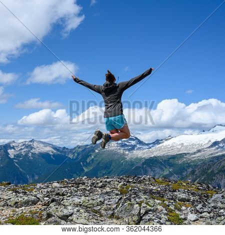 Woman Soars Over Rocky Overlook In North Cascades Wilderness