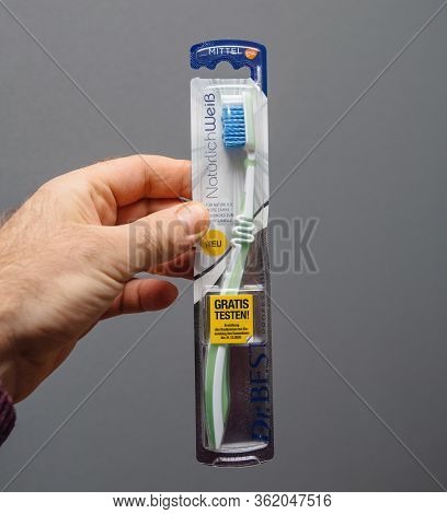 Paris, France - Mar 5, 2020: Square Image Pov Male Hand Holding Dr Best Toothbrush Against Gray Back