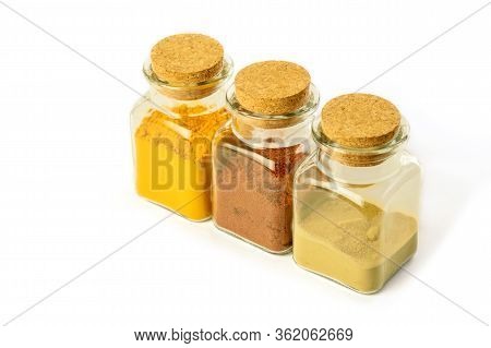 Glass Bottles With Spices On The White Background Isolated. Turmeric Powder, Hot Red Pepper Powder A