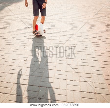 Young Man Driving On Solowheel In The Park.