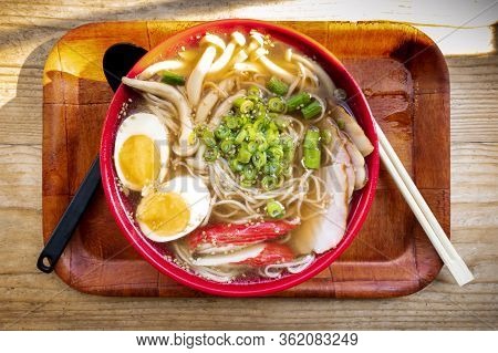 Tonkotsu Ramen Close-up, Shot From The Top, With Eggs, Green Onion And Mushrooams, With Chopsticks O
