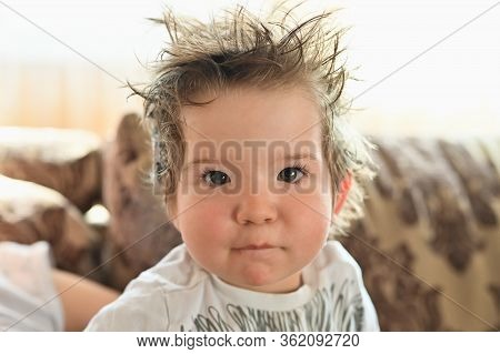 The Child Has Hair Sticking Out. Its Time For The Baby To Get A Haircut. For Long Hair In A Child.