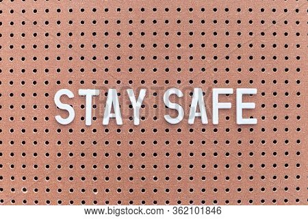 Phrase Stay Safe On Brown Pegboard, Self-isolation Concept,  Horizontal