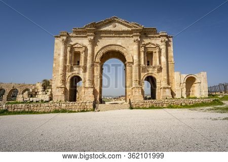 Arch Of Hadrian At The Roman Ruins Of Jerash, Jordan. Front View On A Sunny Day With Blue Sky. It Fe