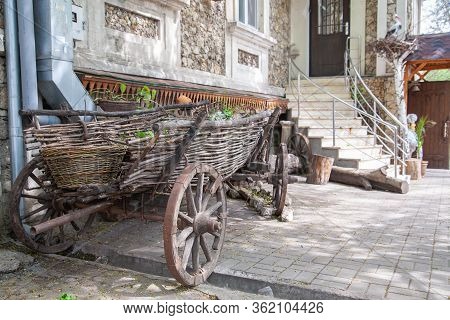 Old Cart In The Courtyard Of A Village Stone House