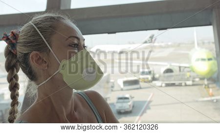 Woman Caucasian At Airport With Wearing Protective Medical Mask On Head Against The Background Of Th