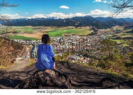 Lonely Boy Sitting On Top Of The Hill Cebrat And Looking At Town Ruzomberok, Slovakia