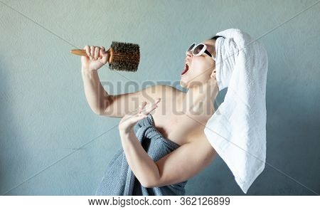 Girl Sings In A Comb On Her Head Wound A White Towel, Concept Of A Home Concert In Isolation, Rehear