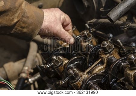 Checking The Thermal Clearances Of The Intake Valves Of The Gasoline Engine. An Elderly Mechanic Che