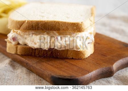 Homemade Tasty Pimento Cheese Sandwich With Chips On A Rustic Wooden Board, Side View. Close-up.
